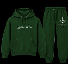Load image into Gallery viewer, A dark green two-piece hoodie and sweatpants set on a plain white background. The hoodie features the text 'God's Plan > My Plan' printed in white on the chest, and the matching sweatpants feature a white graphic with a cross and scripture text on the left thigh.